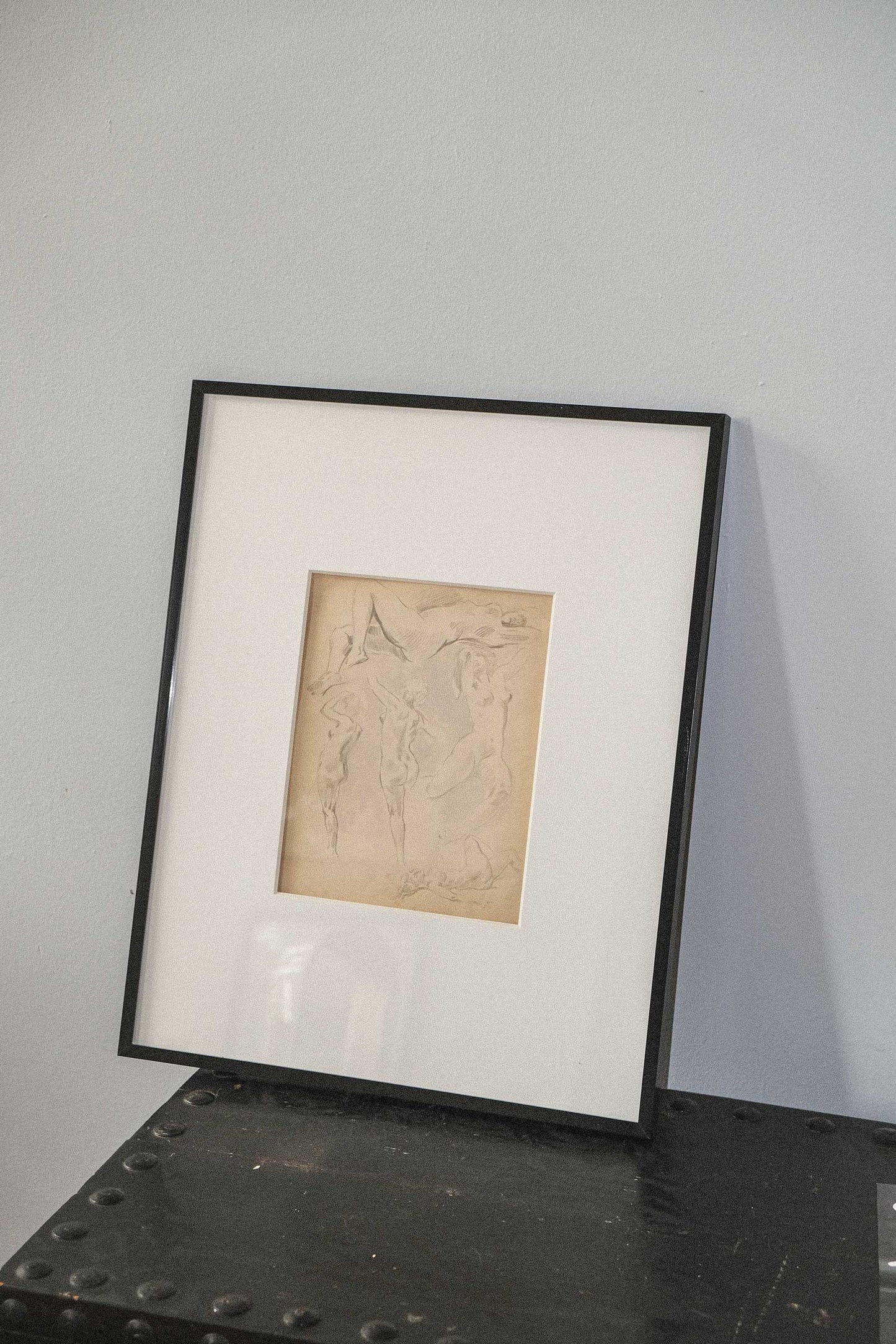 Framed artwork on a metal surface with a gray background